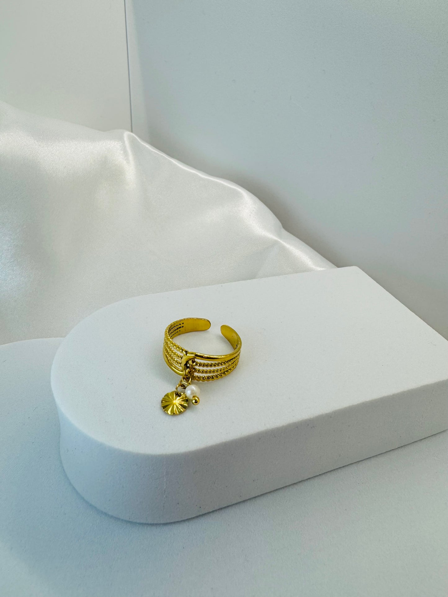 Bagues dorées ajustables avec pendentifs fleur et rond.