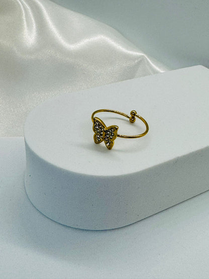 Bagues dorées ajustables avec papillon en strass.