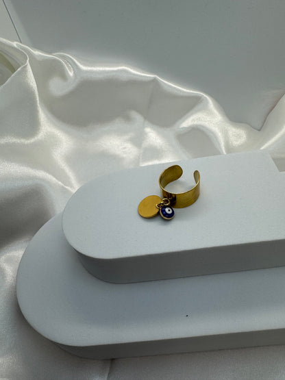 Bagues dorées ajustables avec pendentif rond et œil bleu porte bonheur.