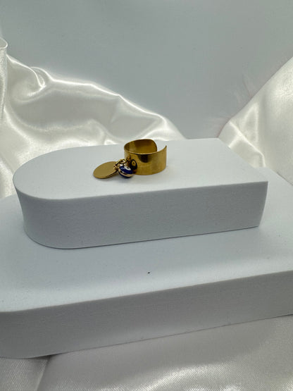 Bagues dorées ajustables avec pendentif rond et œil bleu porte bonheur.