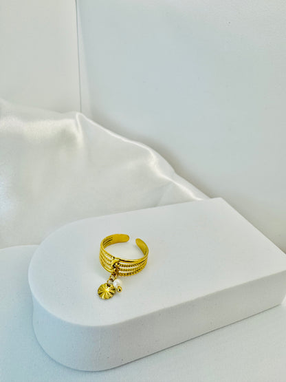 Bagues dorées ajustables avec pendentifs fleur et rond.
